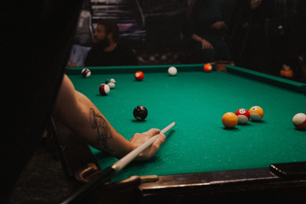 Pool table with billiard balls racked and ready for break shot