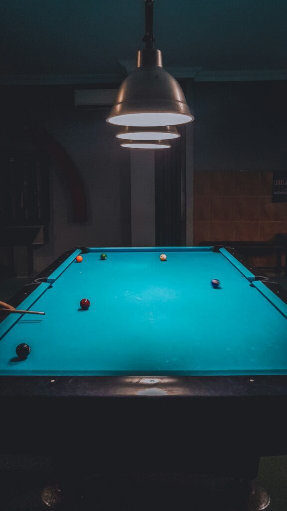 Billiard table under warm lighting in a competition setting