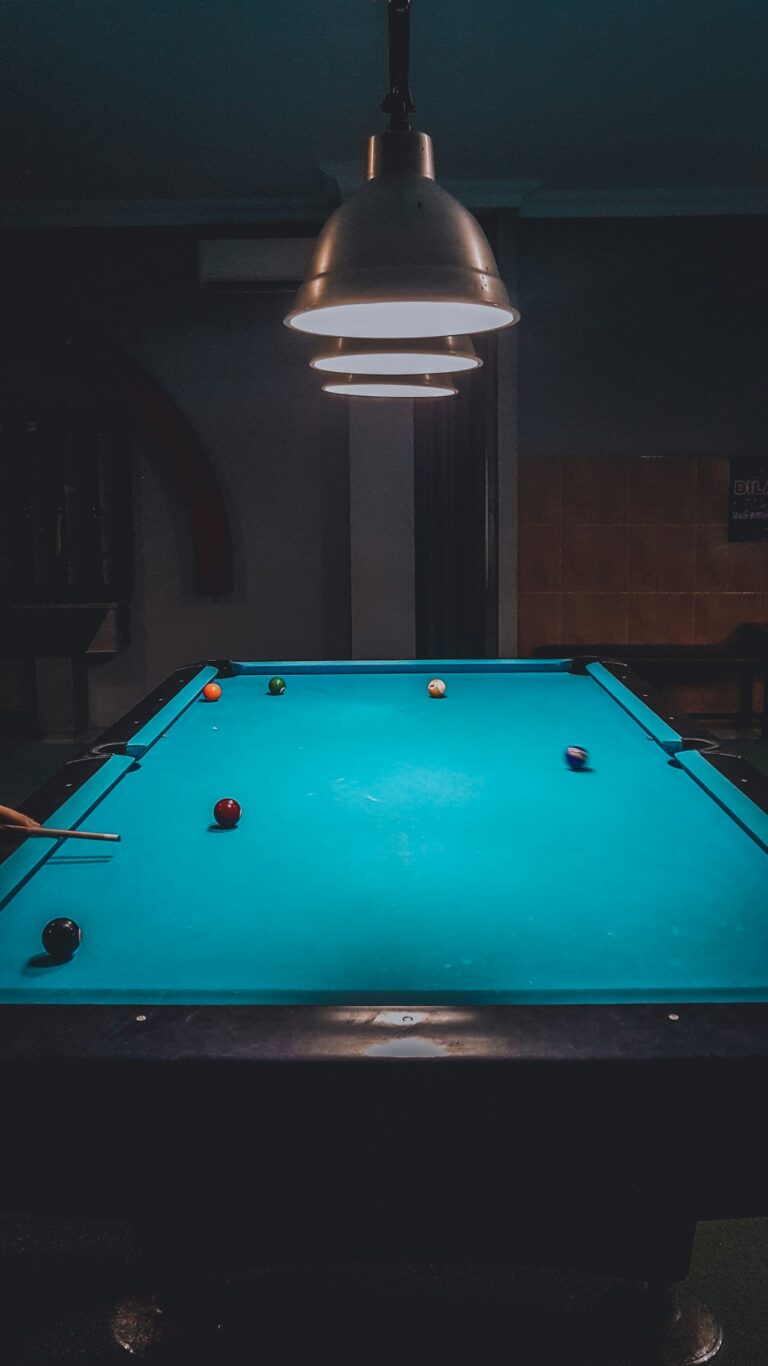 Billiard table under warm lighting in a competition setting