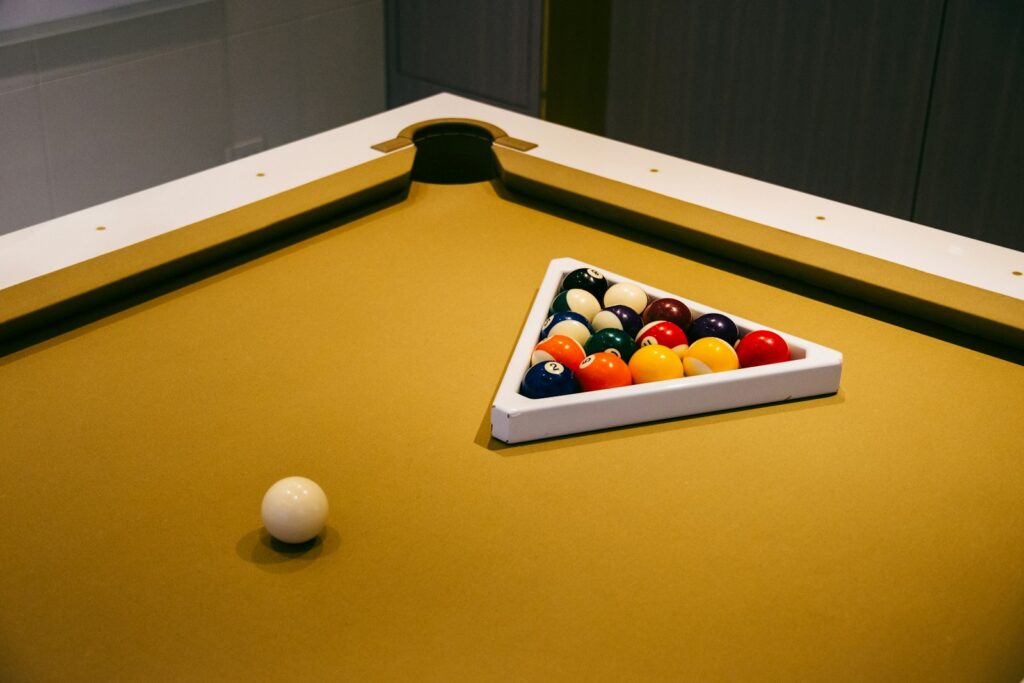 Billiard balls on a pool table, one pocket pool game setup